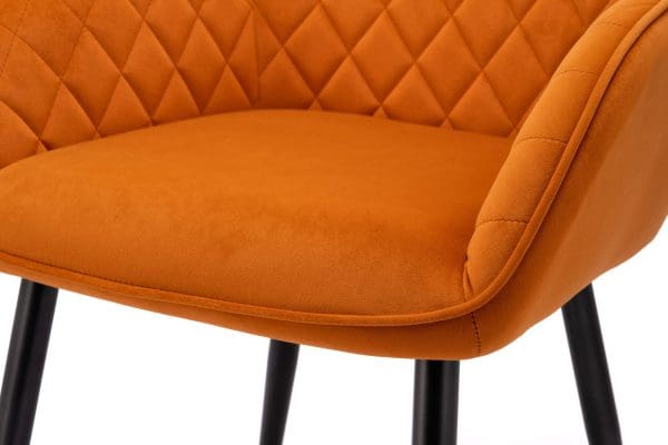 Orange velvet dining chair close up